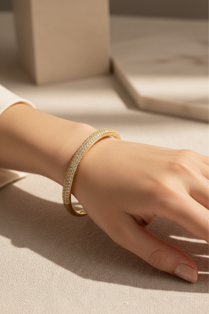 Elegant woman wearing full pavé zirconia gold bangle