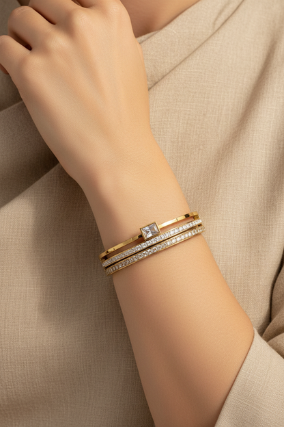 Elegant woman wearing gold cuff bangle with zirconia
