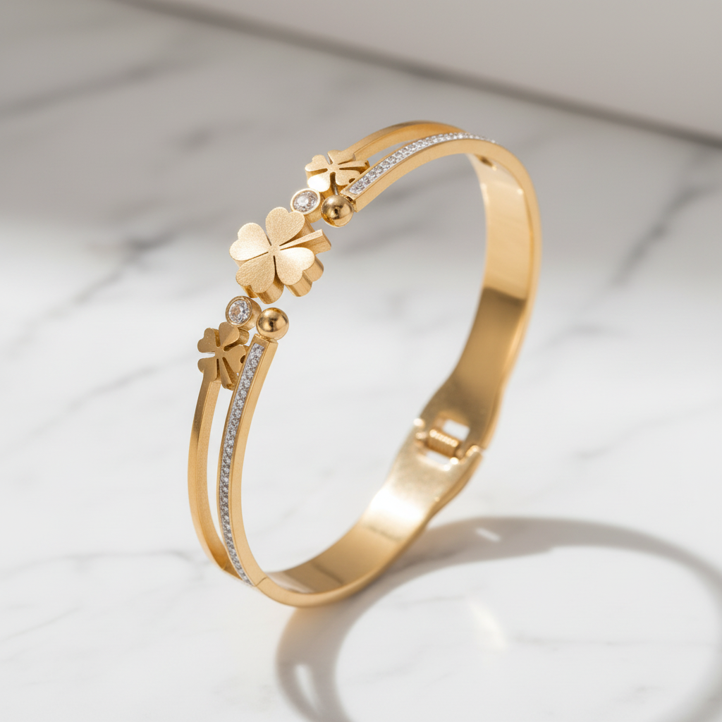 Gold clover bangle on elegant marble background