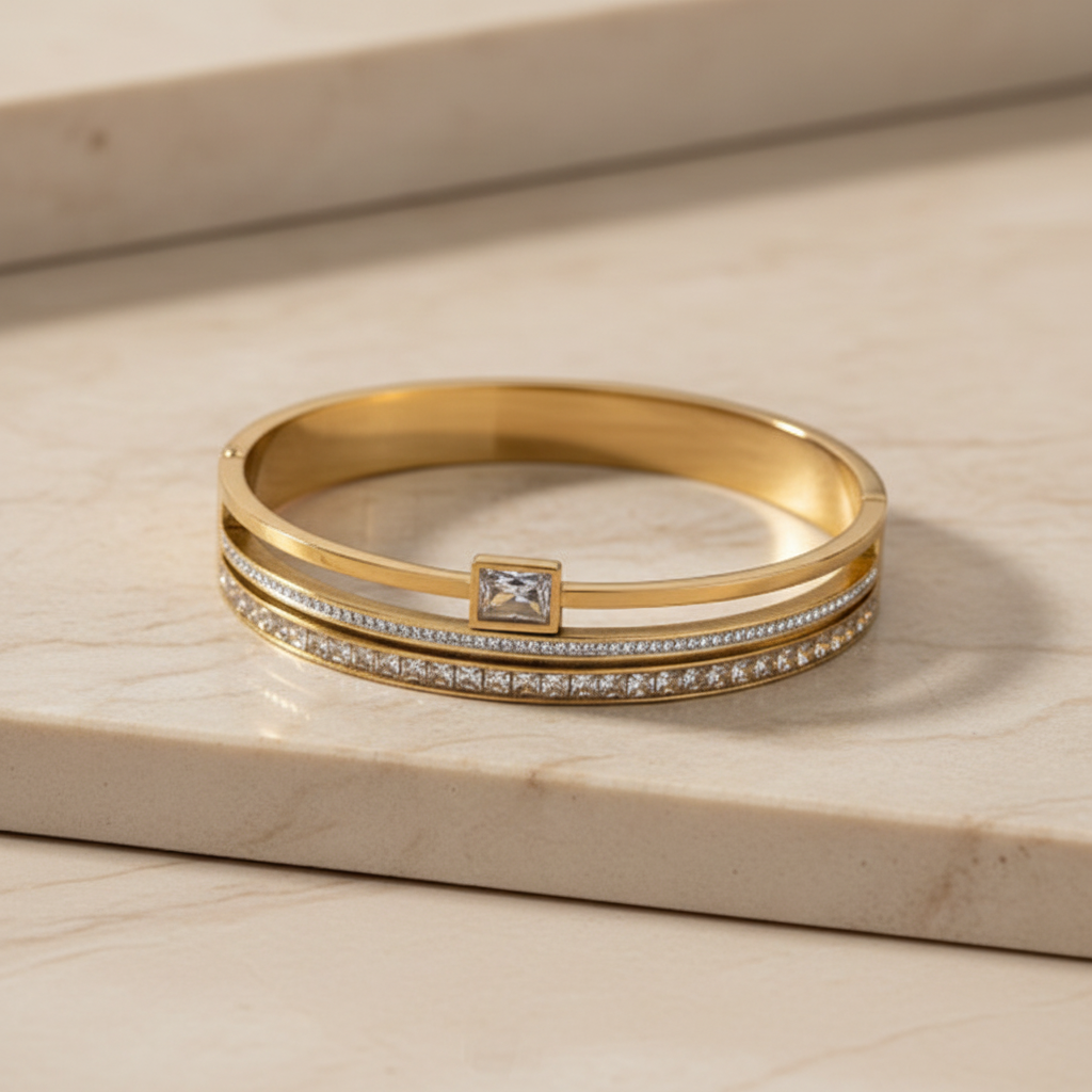 Gold cuff bangle on beige marble
