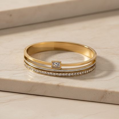 Gold cuff bangle on beige marble