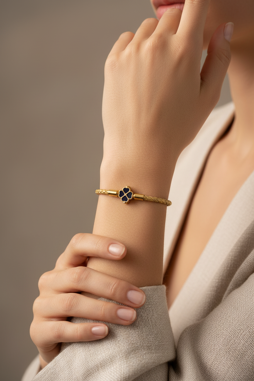 Gold leather clover bracelet on woman's wrist