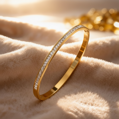 Gold zirconia bangle on cream fabric
