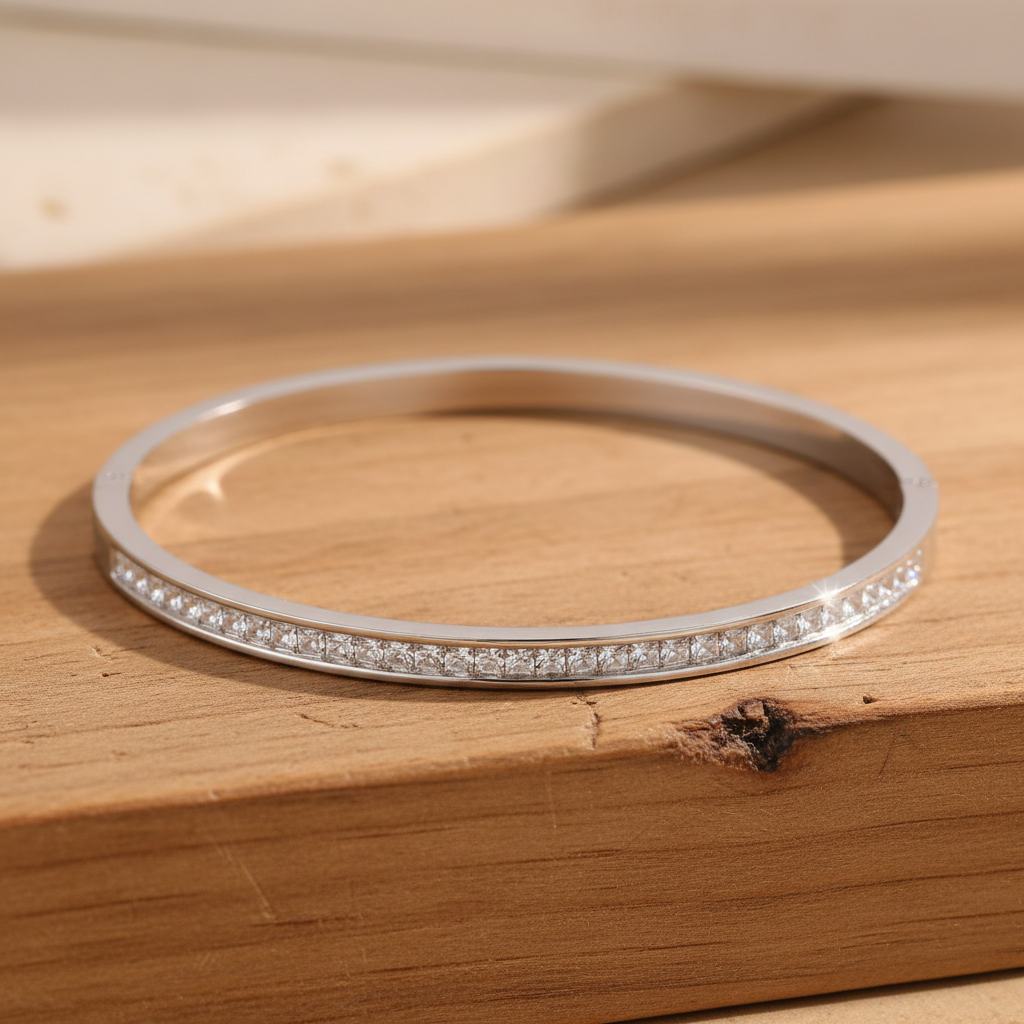 Silver zirconia bangle on wooden surface
